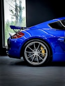 a blue sports car parked in a garage