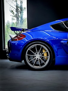 a blue sports car parked in a garage