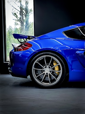 a blue sports car parked in a garage