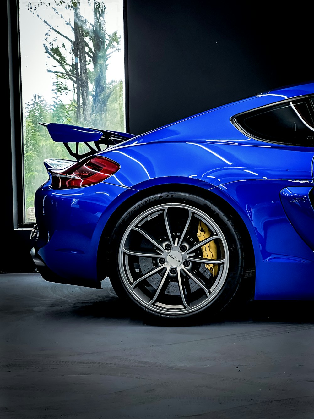 a blue sports car parked in a garage