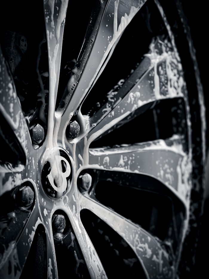 Close-up of a tire and panel on a car during detailing work