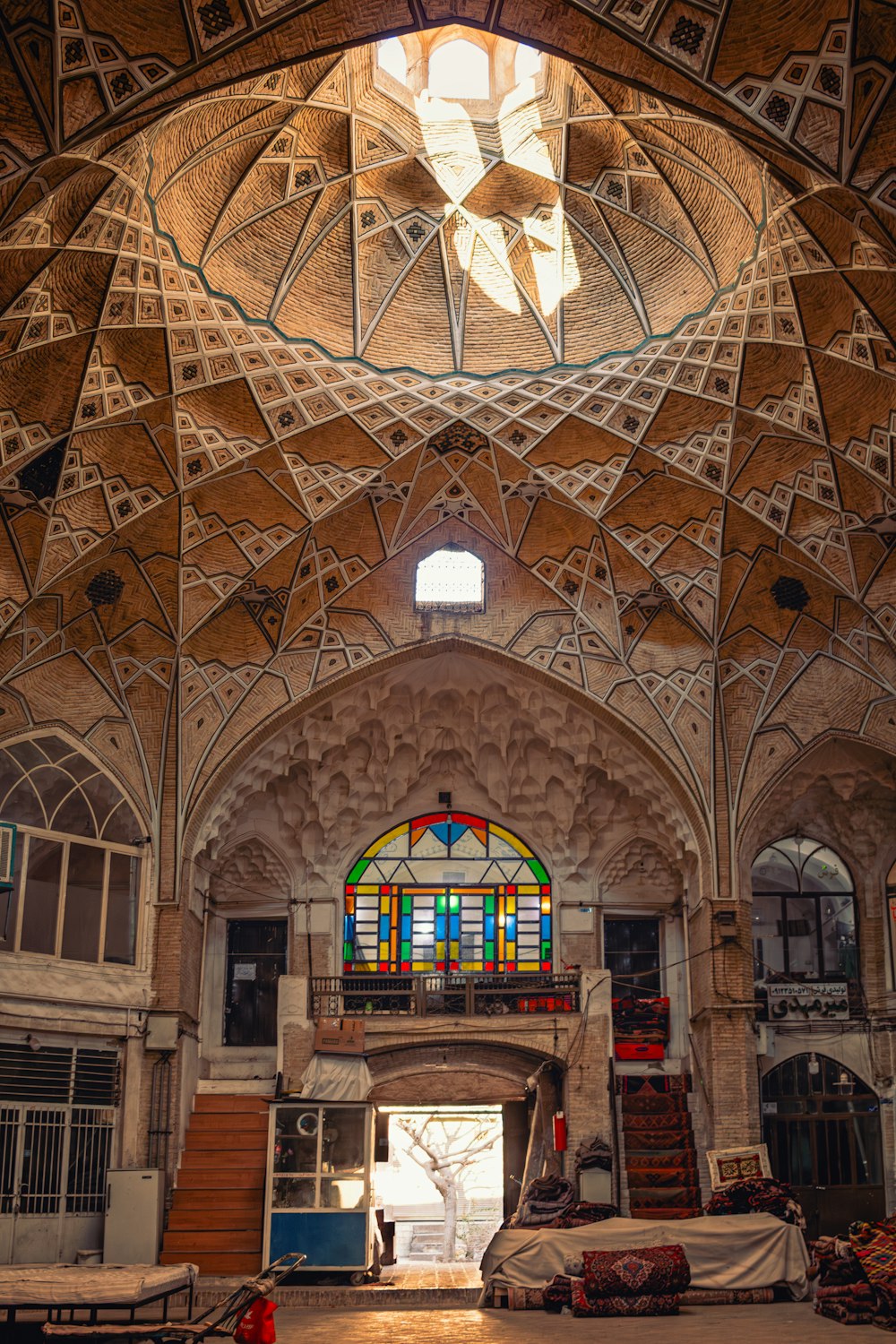 the inside of a building with a large stained glass window