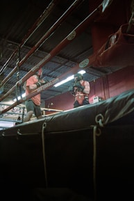 a couple of men standing on top of a wrestling ring