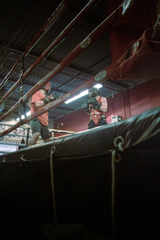 a couple of men standing on top of a wrestling ring