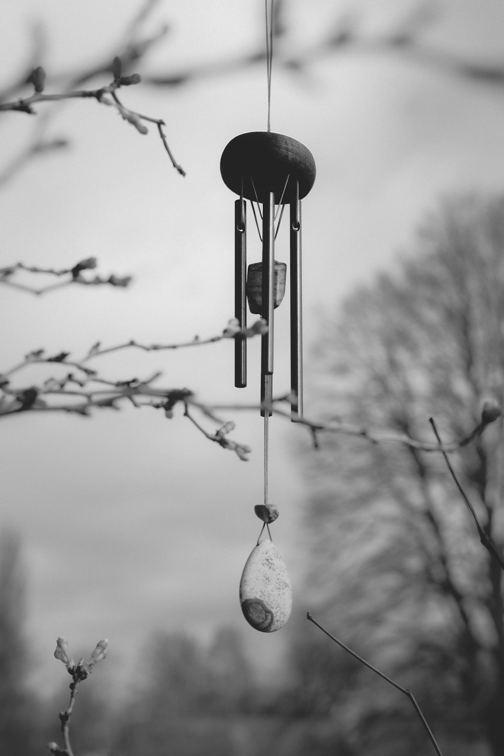a black and white photo of a wind chime