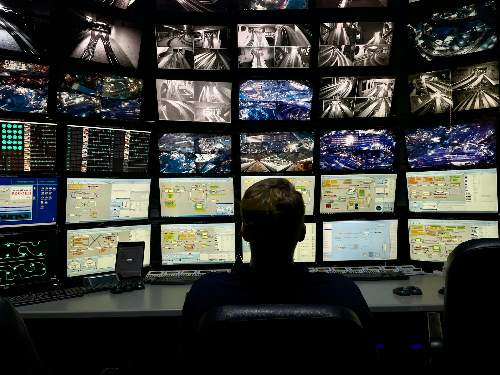 a man sitting in front of multiple monitors