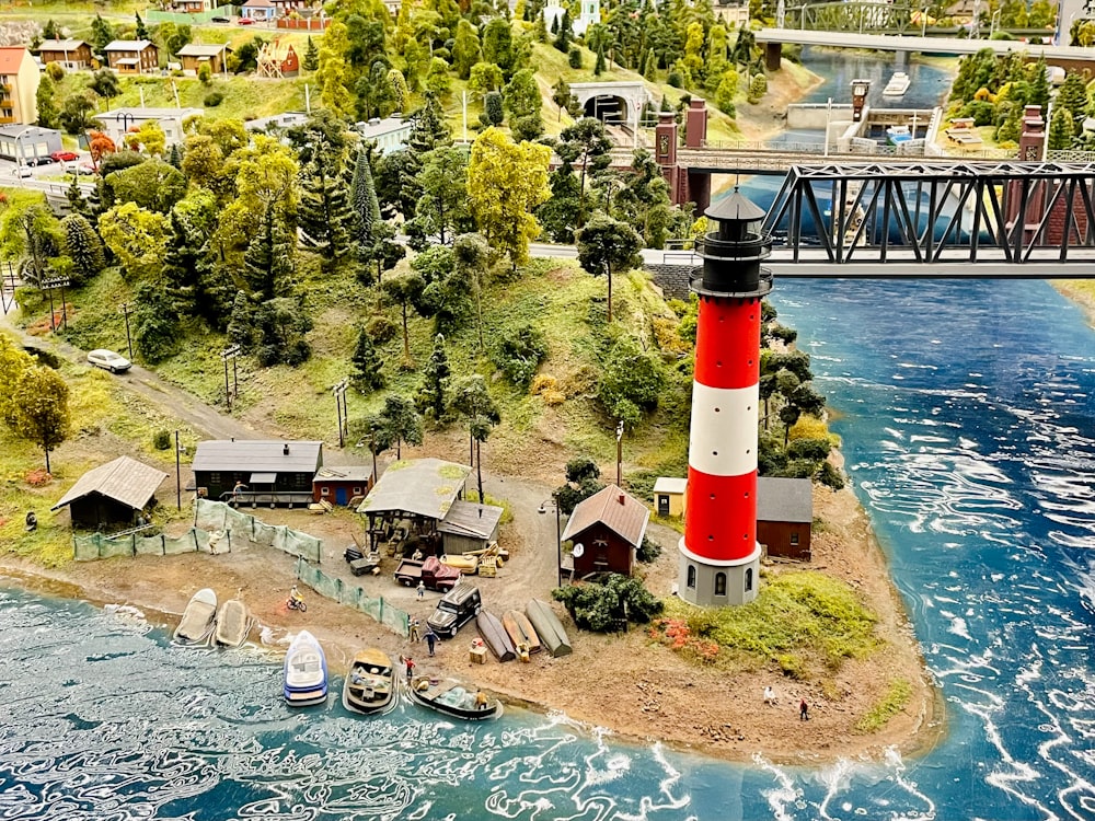 a small island with a red and white lighthouse