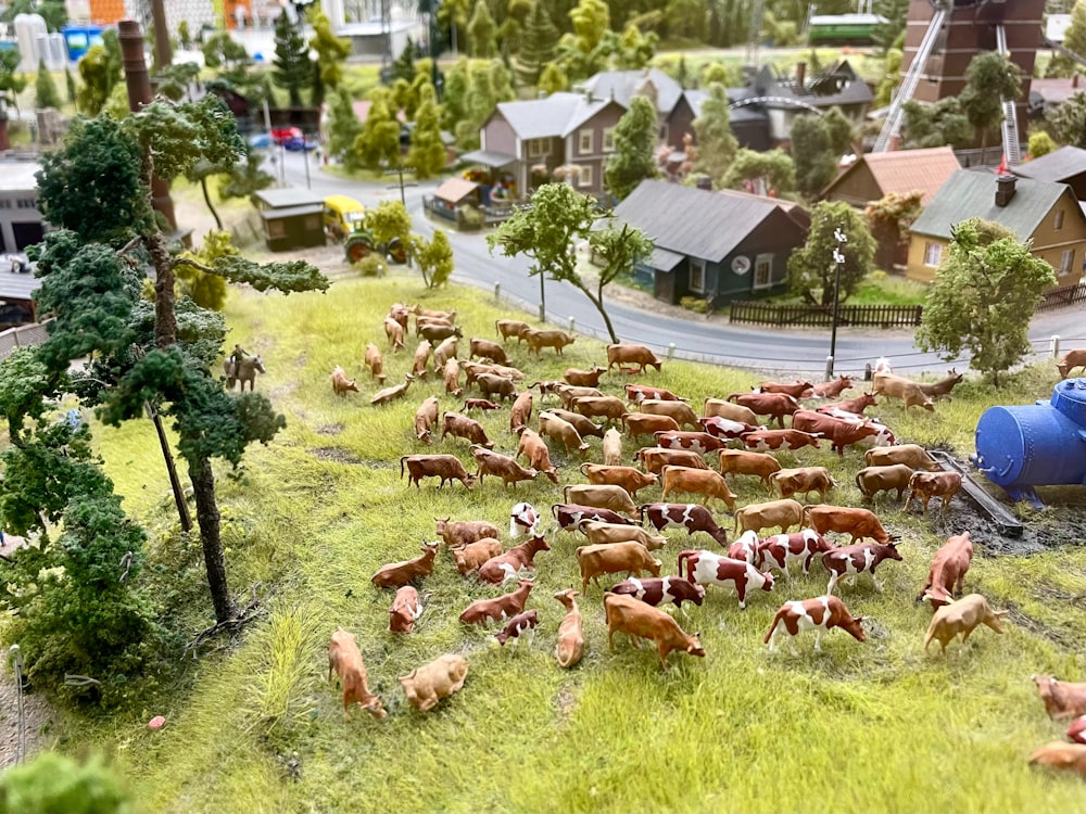 a herd of cattle grazing on a lush green hillside