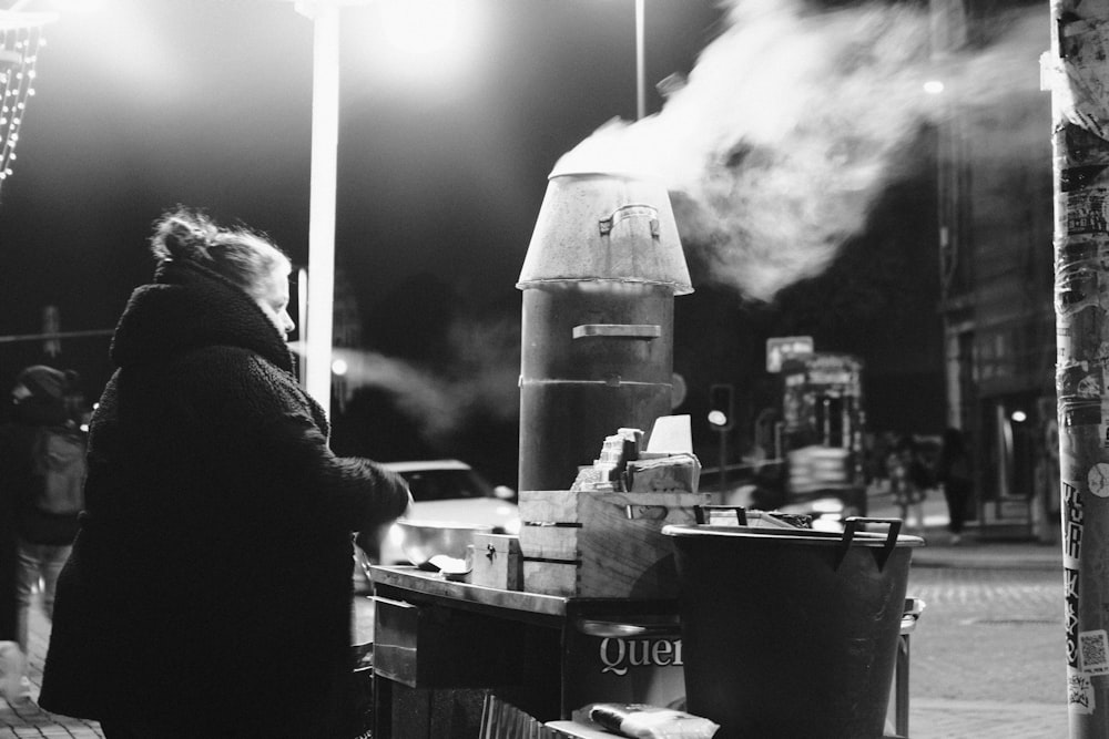 a woman standing in front of a food cart