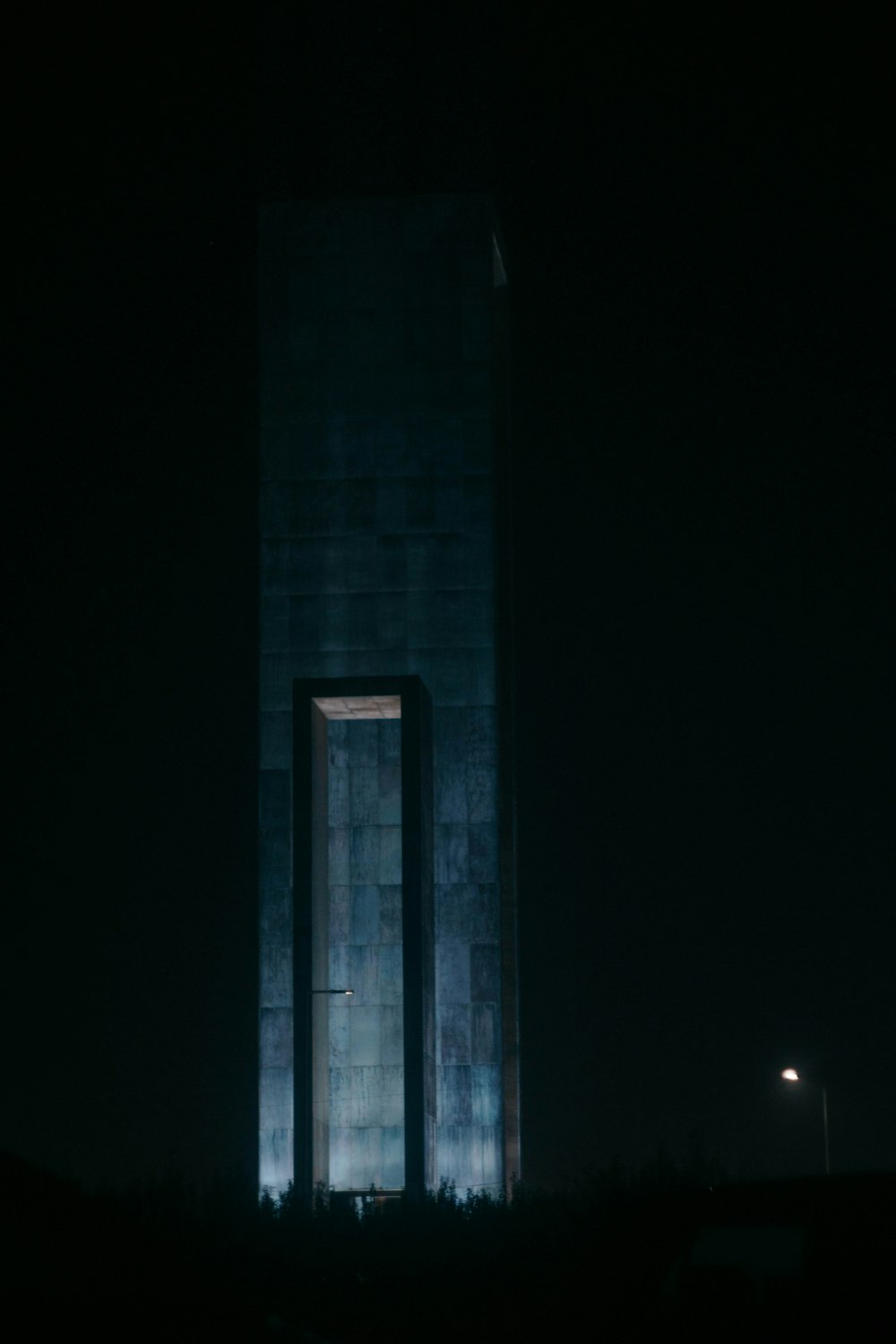 a tall building lit up in the dark