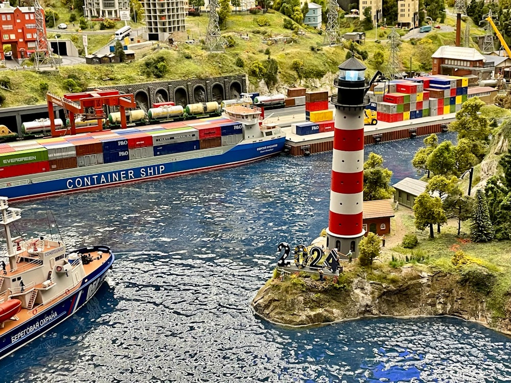 a model of a harbor with boats and a lighthouse