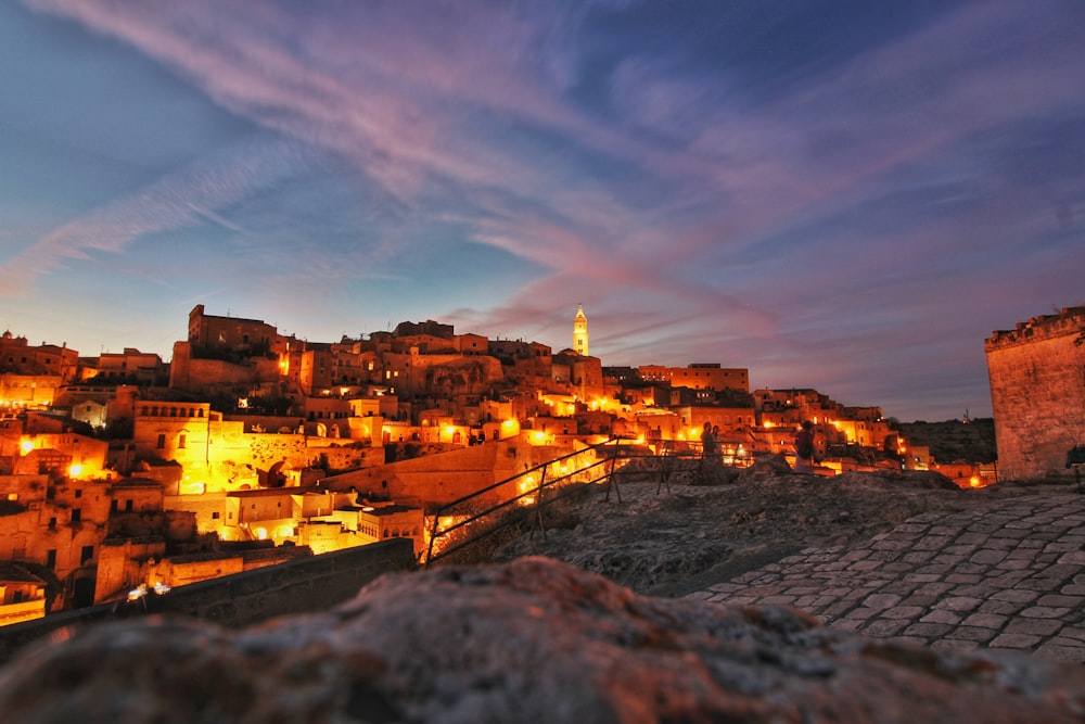 a view of a city at night from a hill