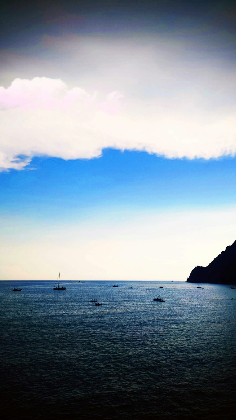 a group of boats floating on top of a large body of water