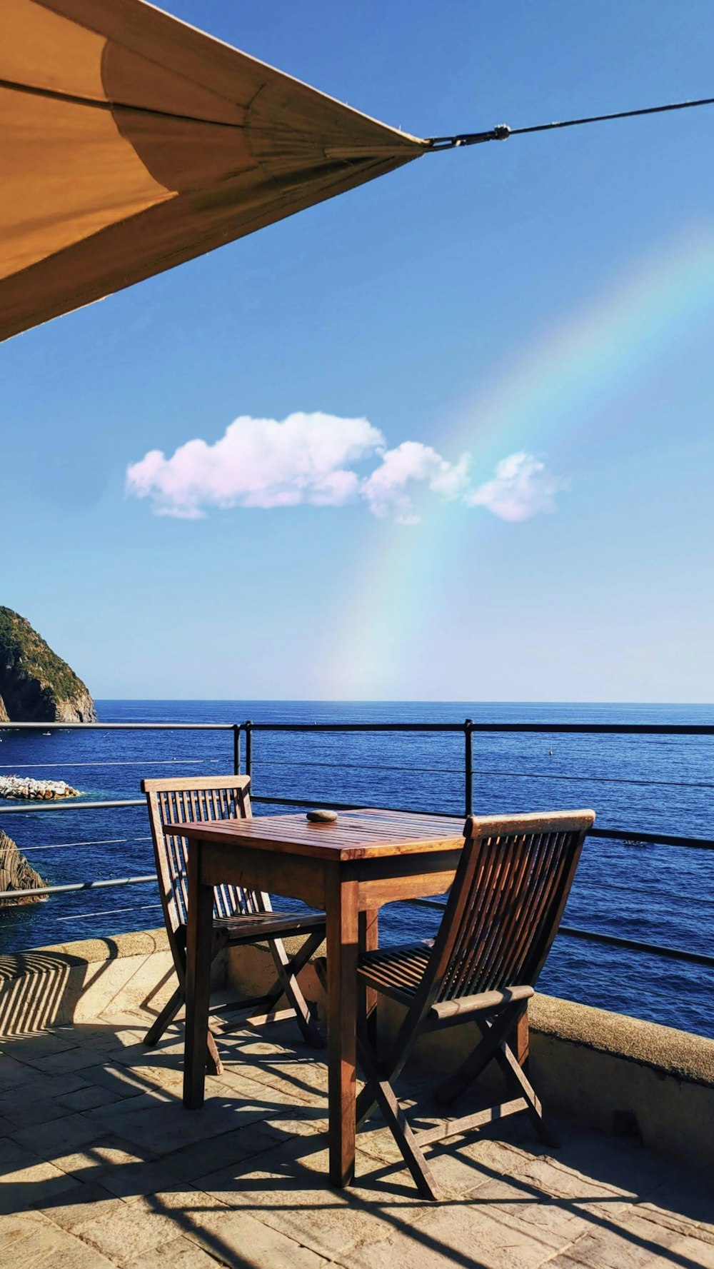 a wooden table sitting on top of a wooden deck