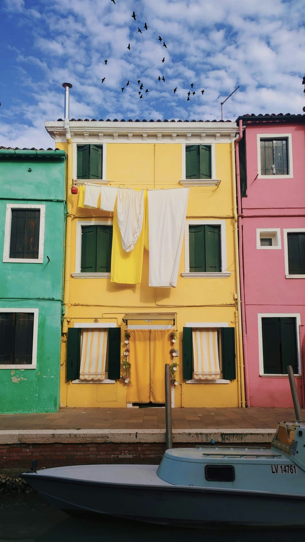 a row of houses with laundry hanging out to dry