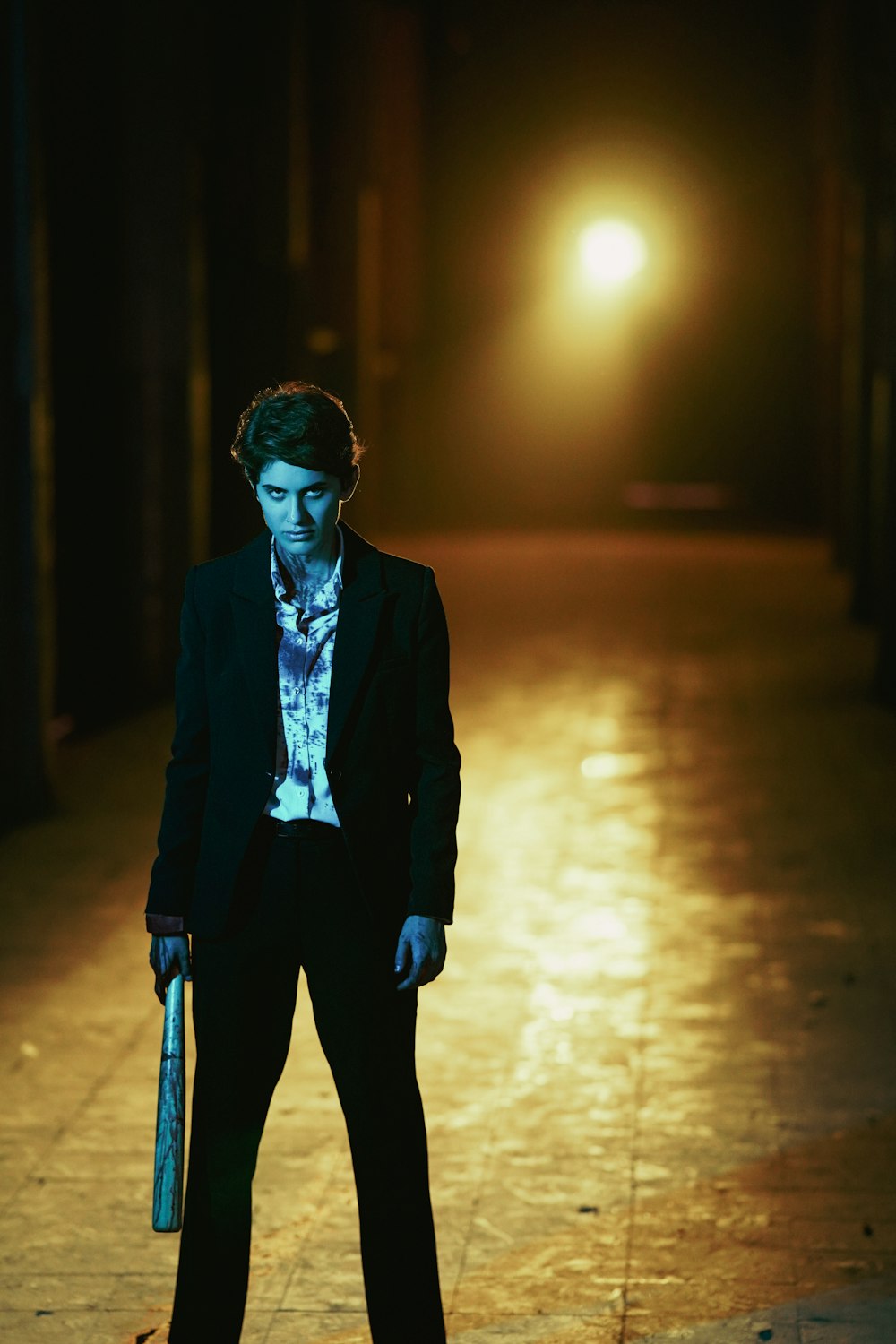 a man in a suit and tie holding a skateboard