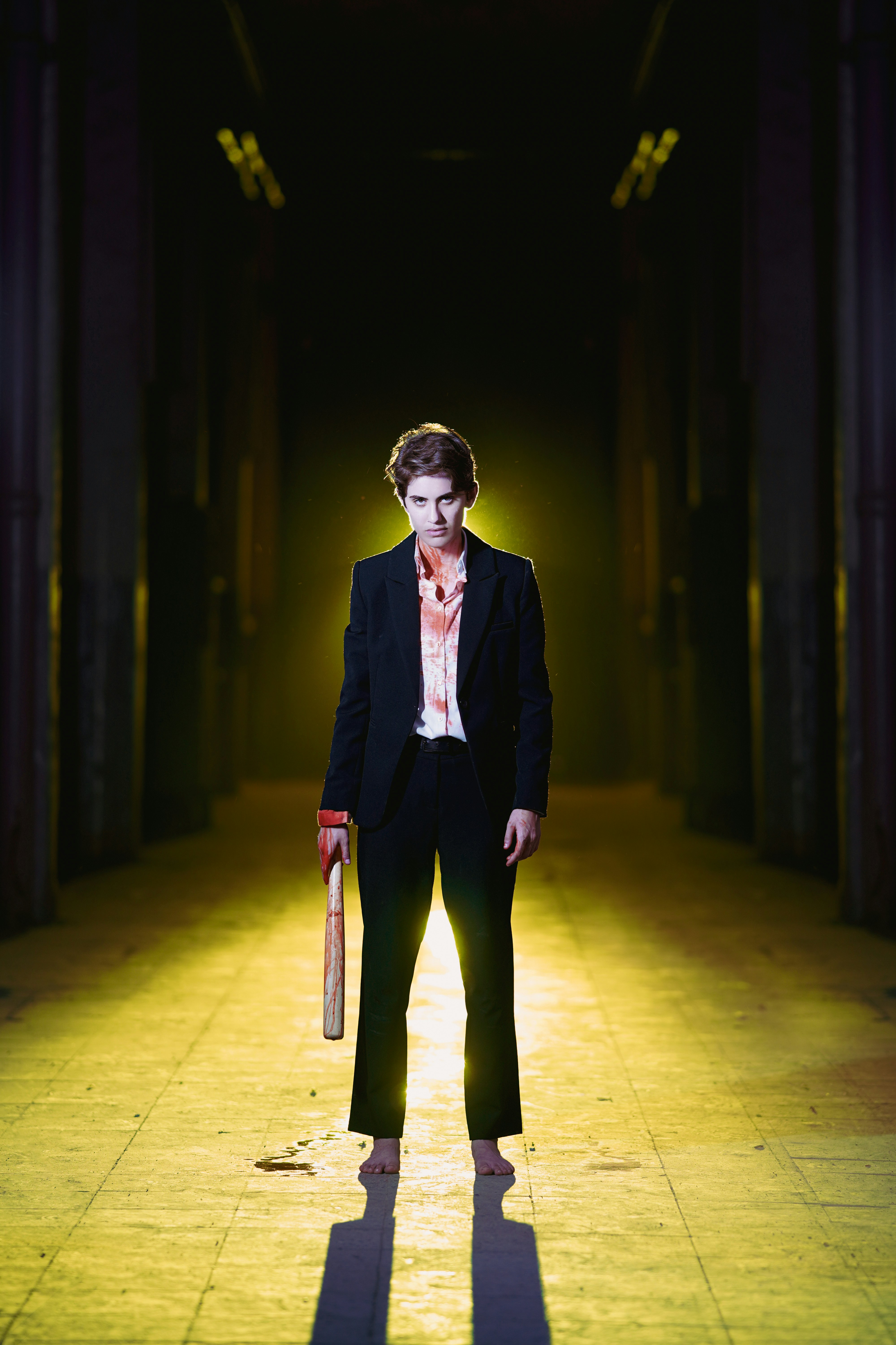 A man in a suit and tie standing in a hallway photo – Free Man Image on ...