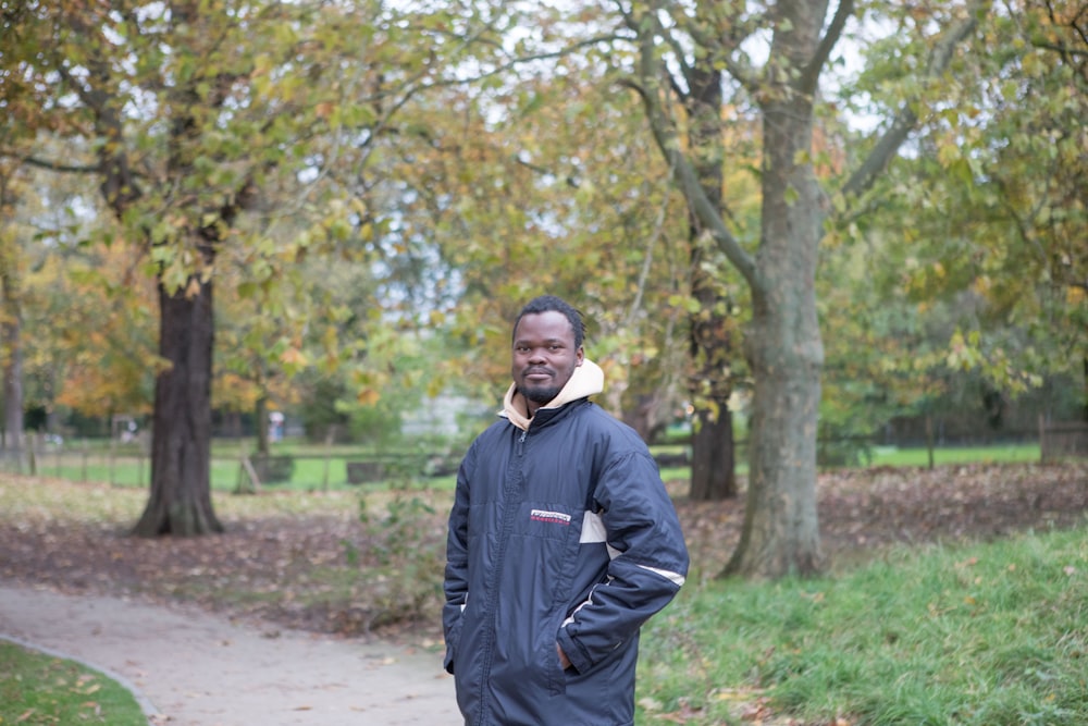 a man standing on a path in a park