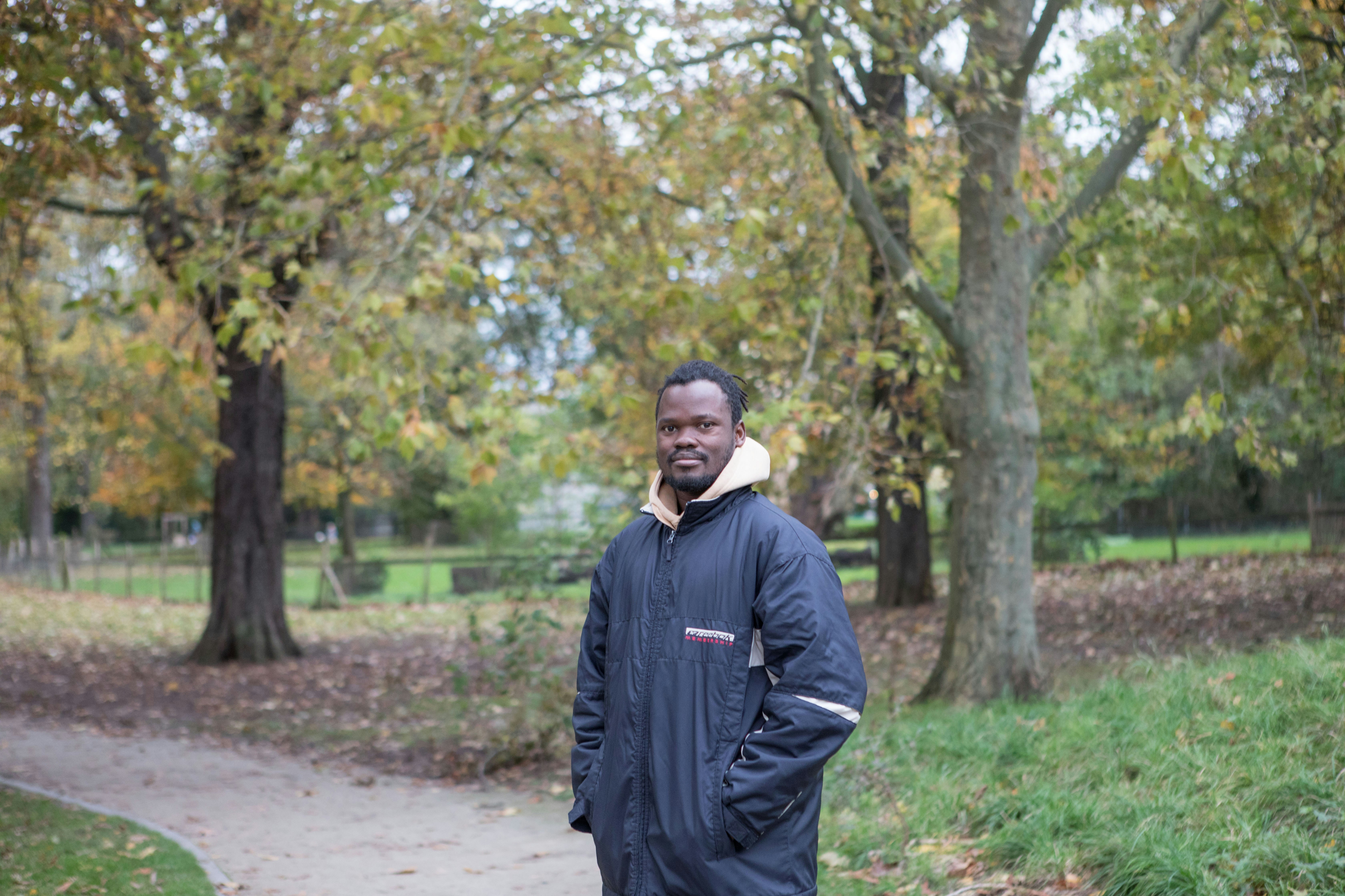 a man standing on a path in a park