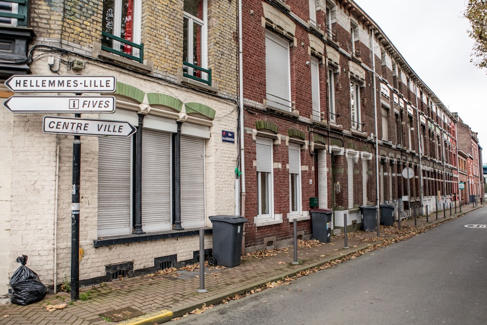 a street sign in front of a row of brick buildings