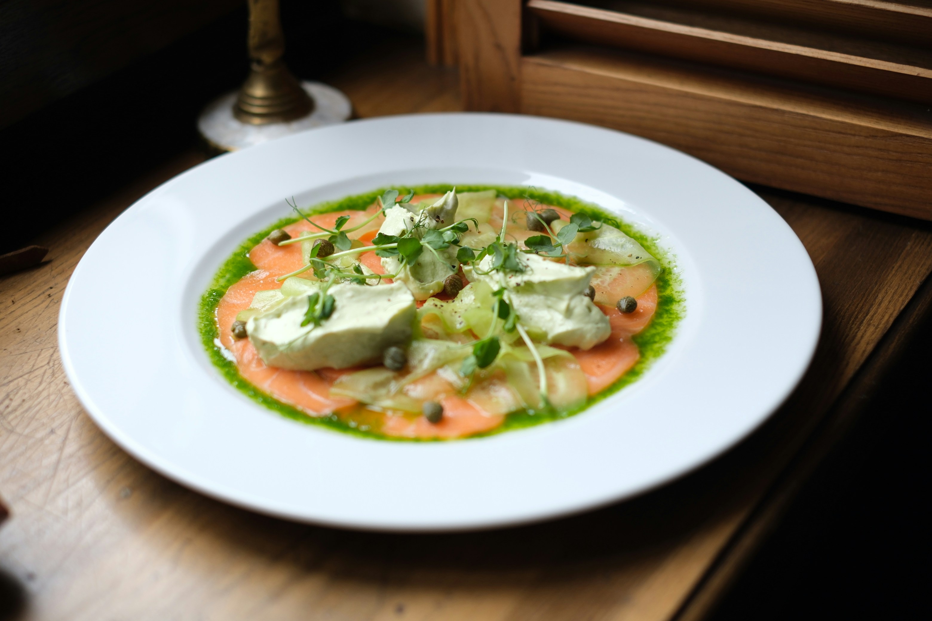 Tofu in green herb sauce in a white bowl