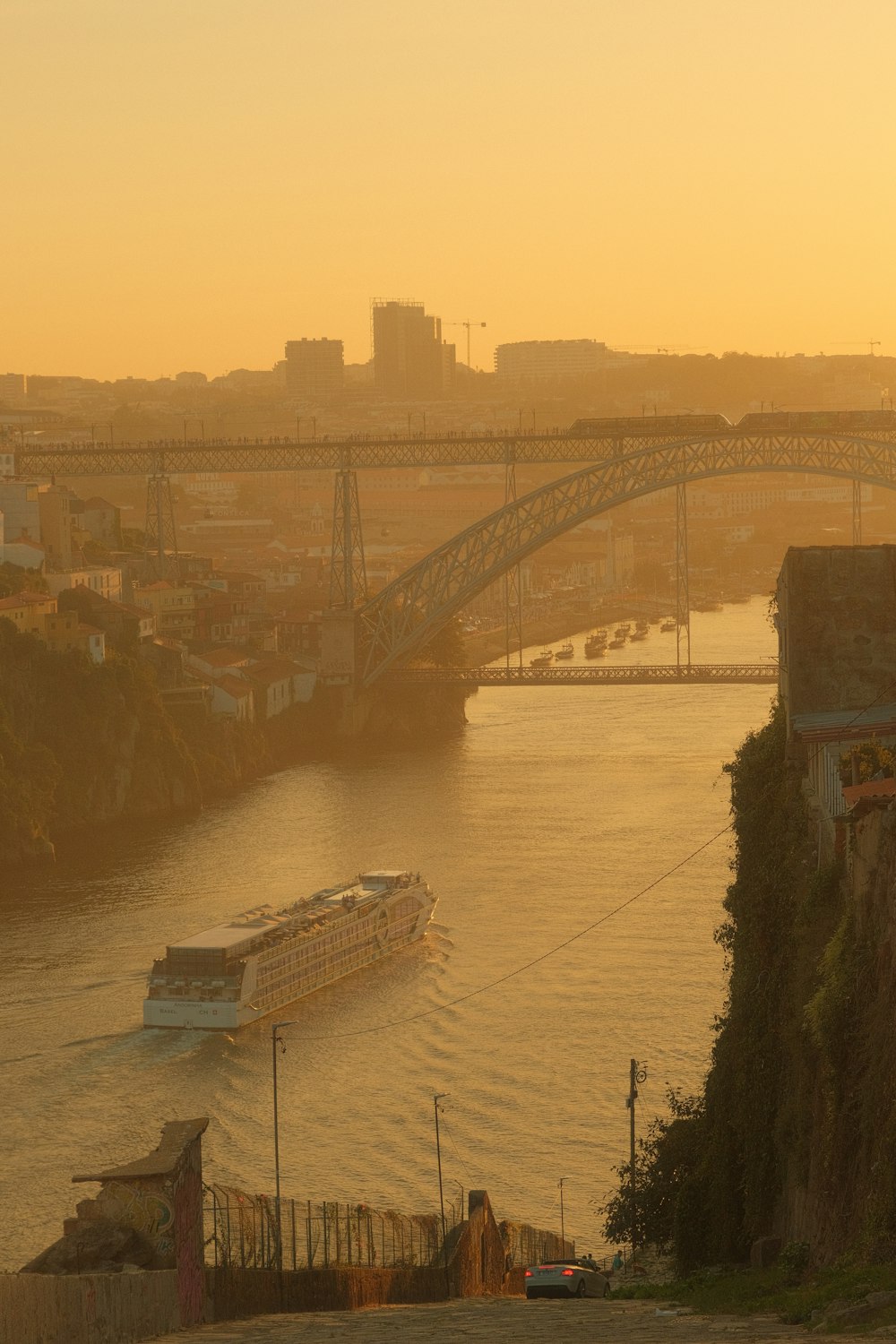 a boat traveling down a river next to a bridge