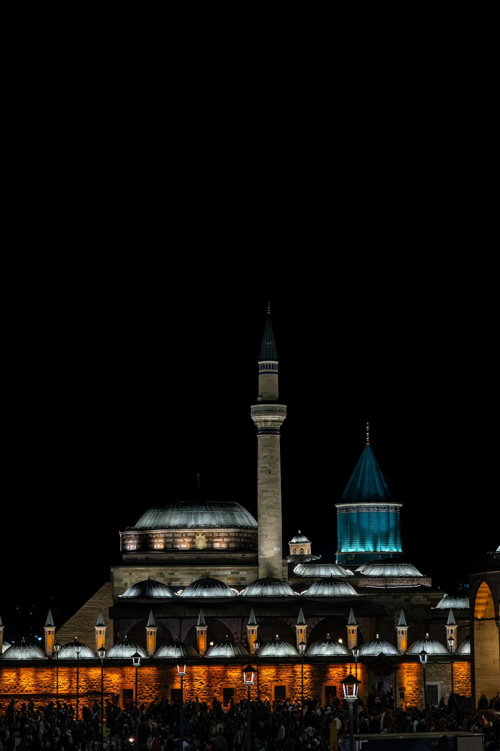 a building lit up at night with a clock tower