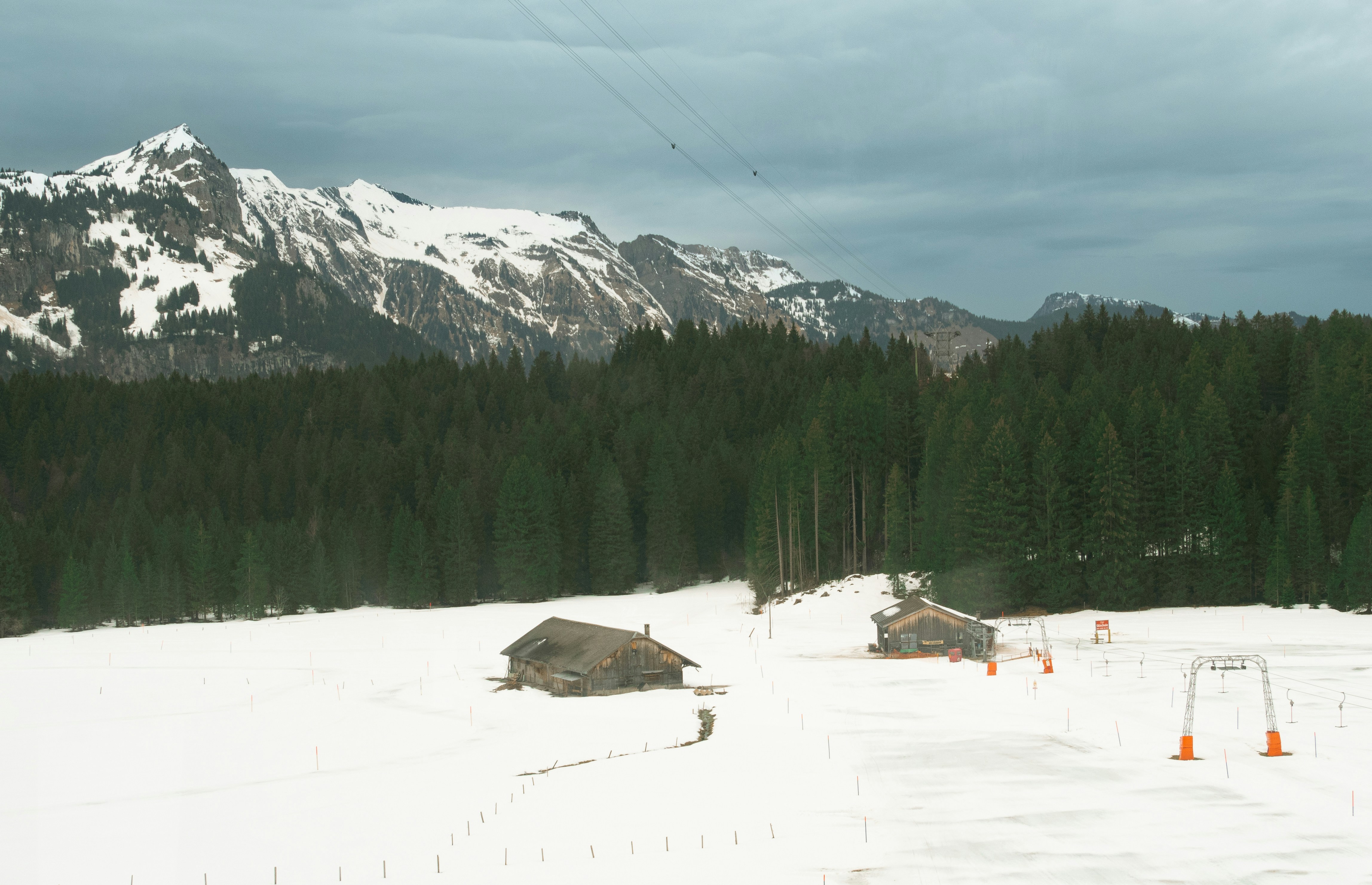 a snow covered field with a mountain in the background