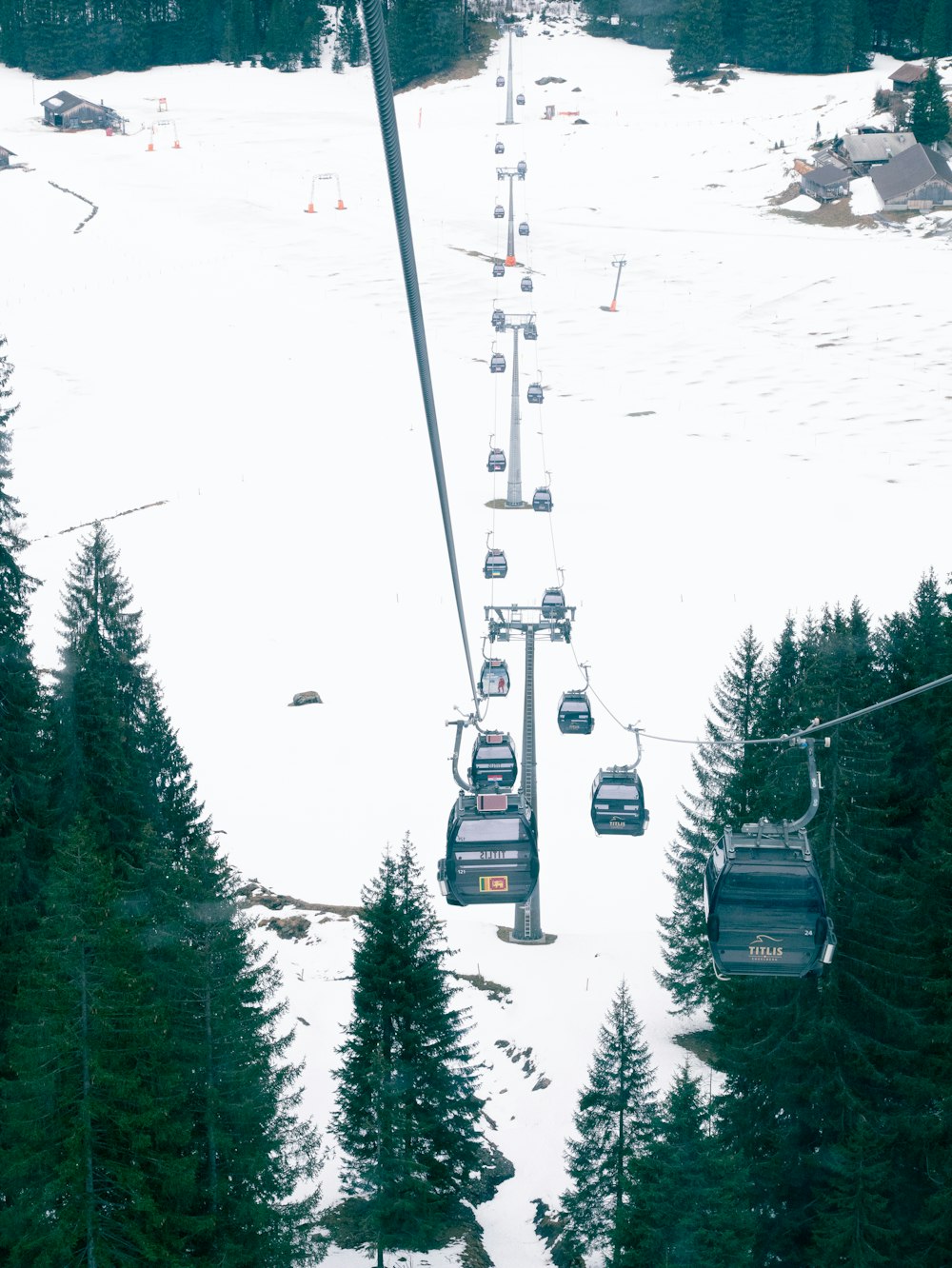 a ski lift going up a snowy mountain