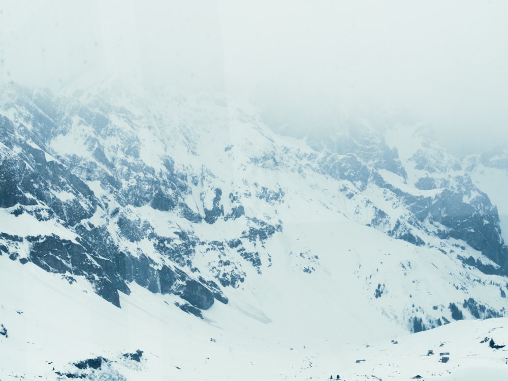 a mountain covered in snow with a sky background