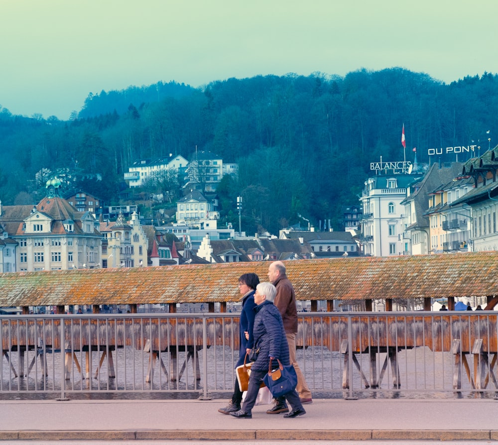 a couple of people walking across a bridge