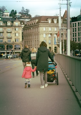 a group of people walking across a bridge