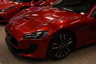 a row of red sports cars parked next to each other