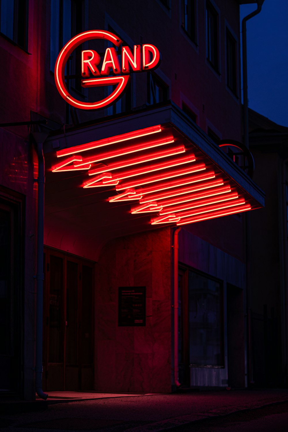 a red neon sign on the side of a building