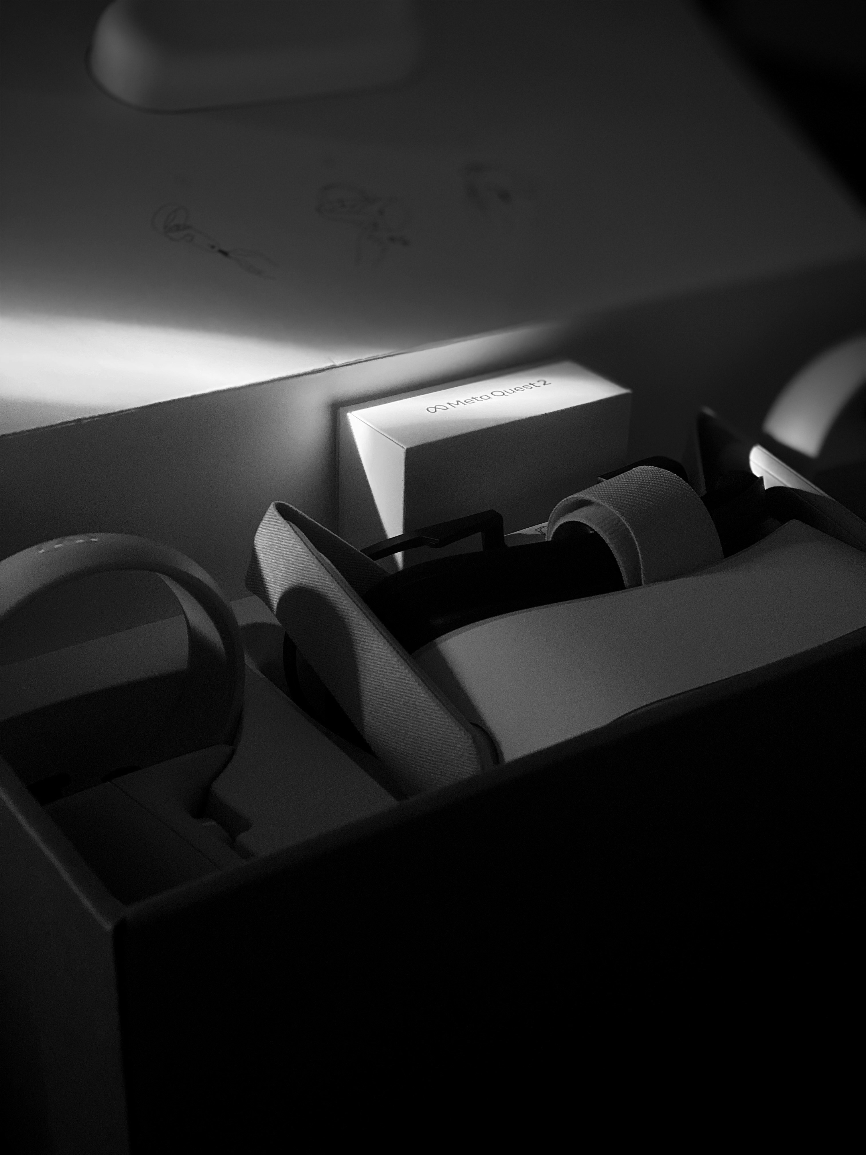 a black and white photo of a box with a pair of headphones in it