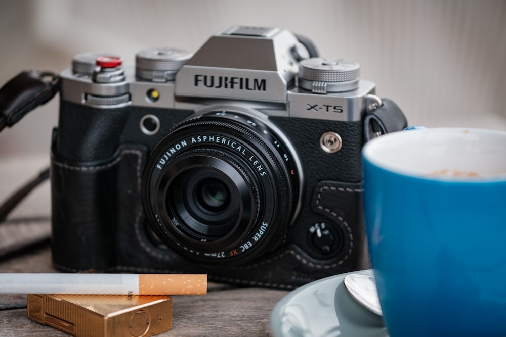 a camera and a cup of coffee on a table