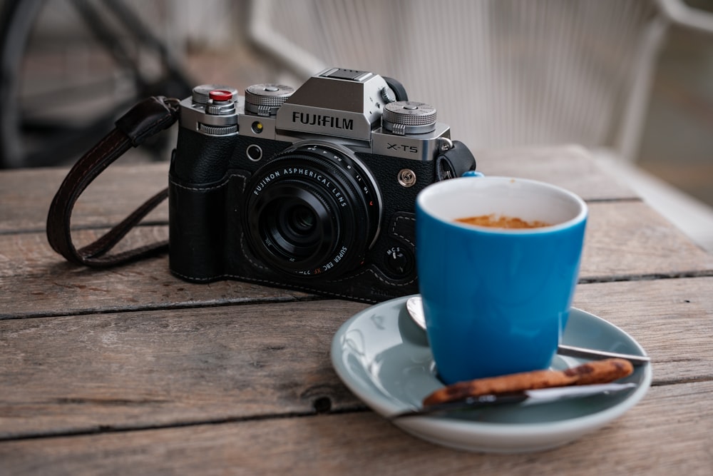 a camera and a cup of coffee on a table