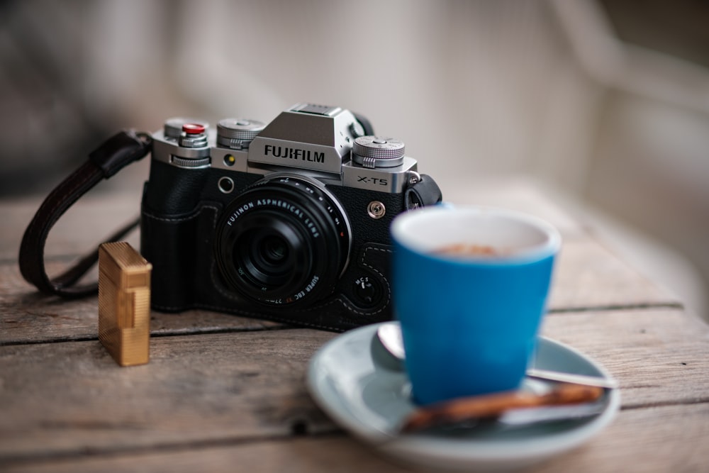 a camera and a cup of coffee on a table