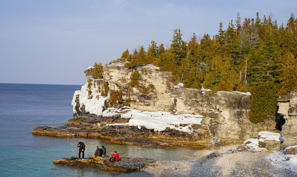 a group of people standing on top of a rock formation