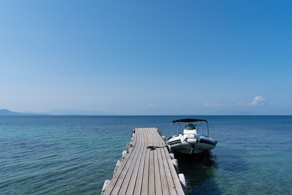 a boat is docked at the end of a pier