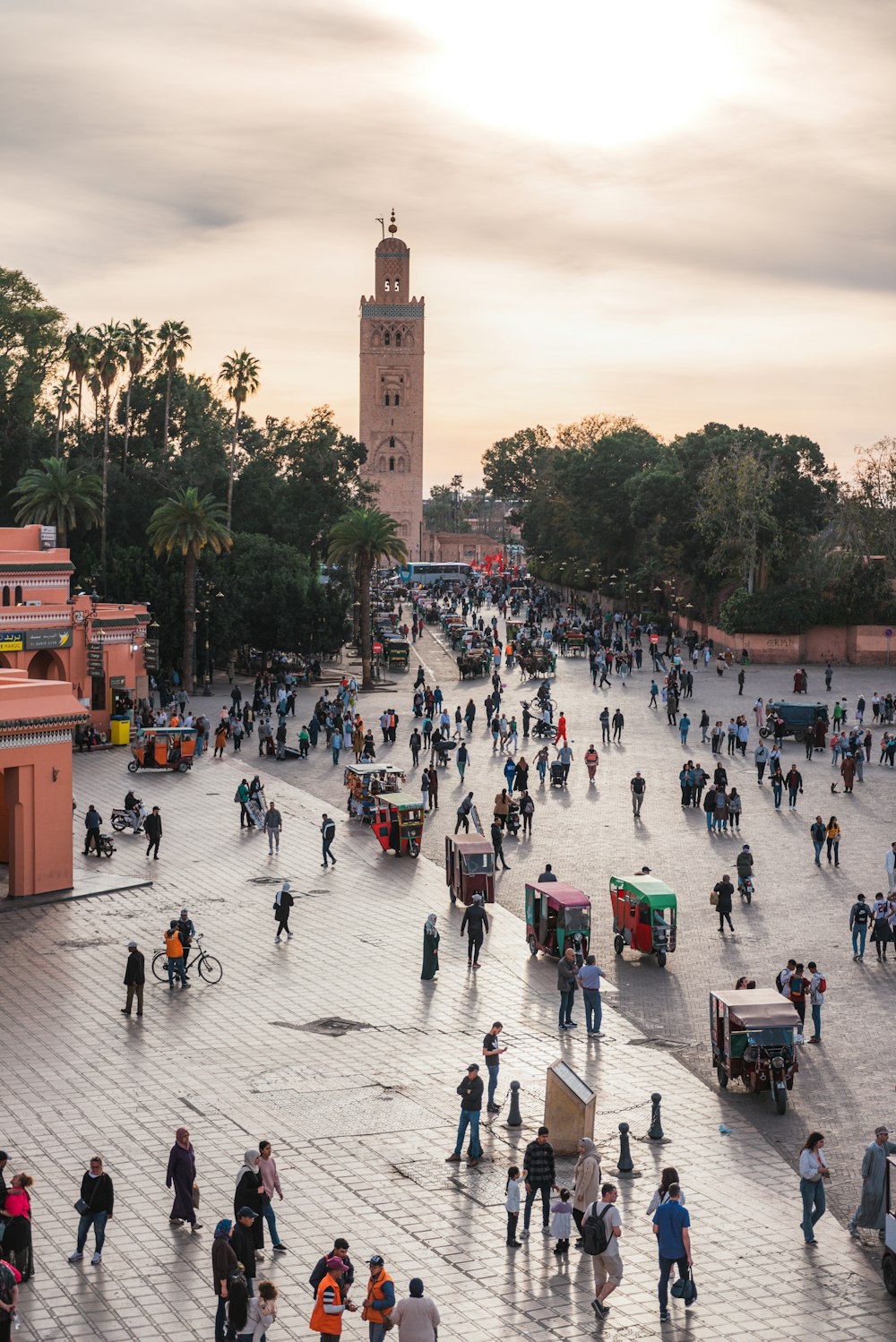 a large group of people walking around a plaza