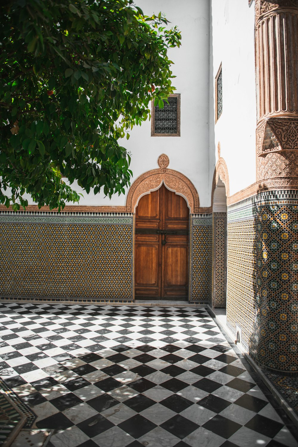 a black and white checkered floor with a wooden door