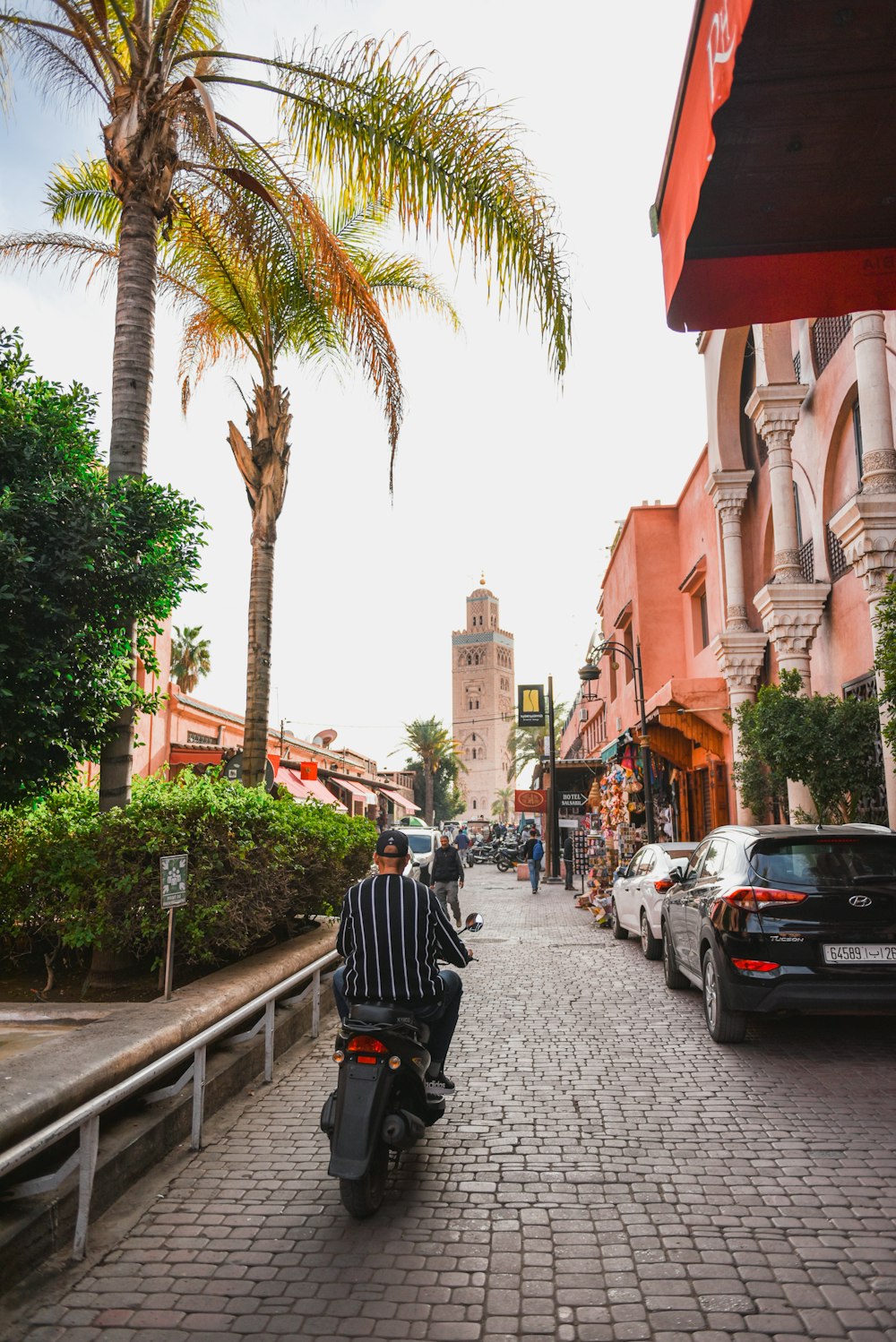 a man riding a motorcycle down a street