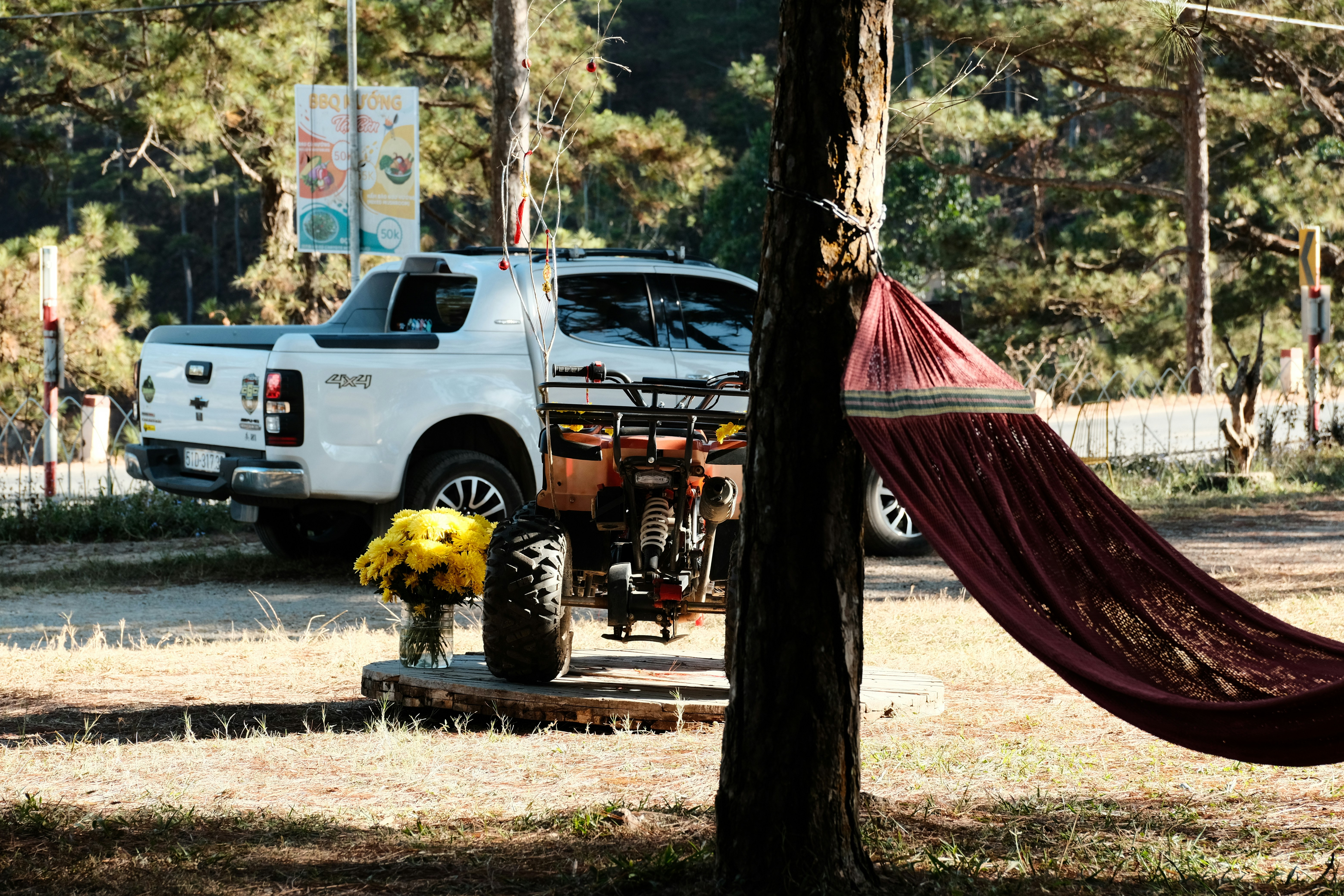 a white truck parked next to a red hammock