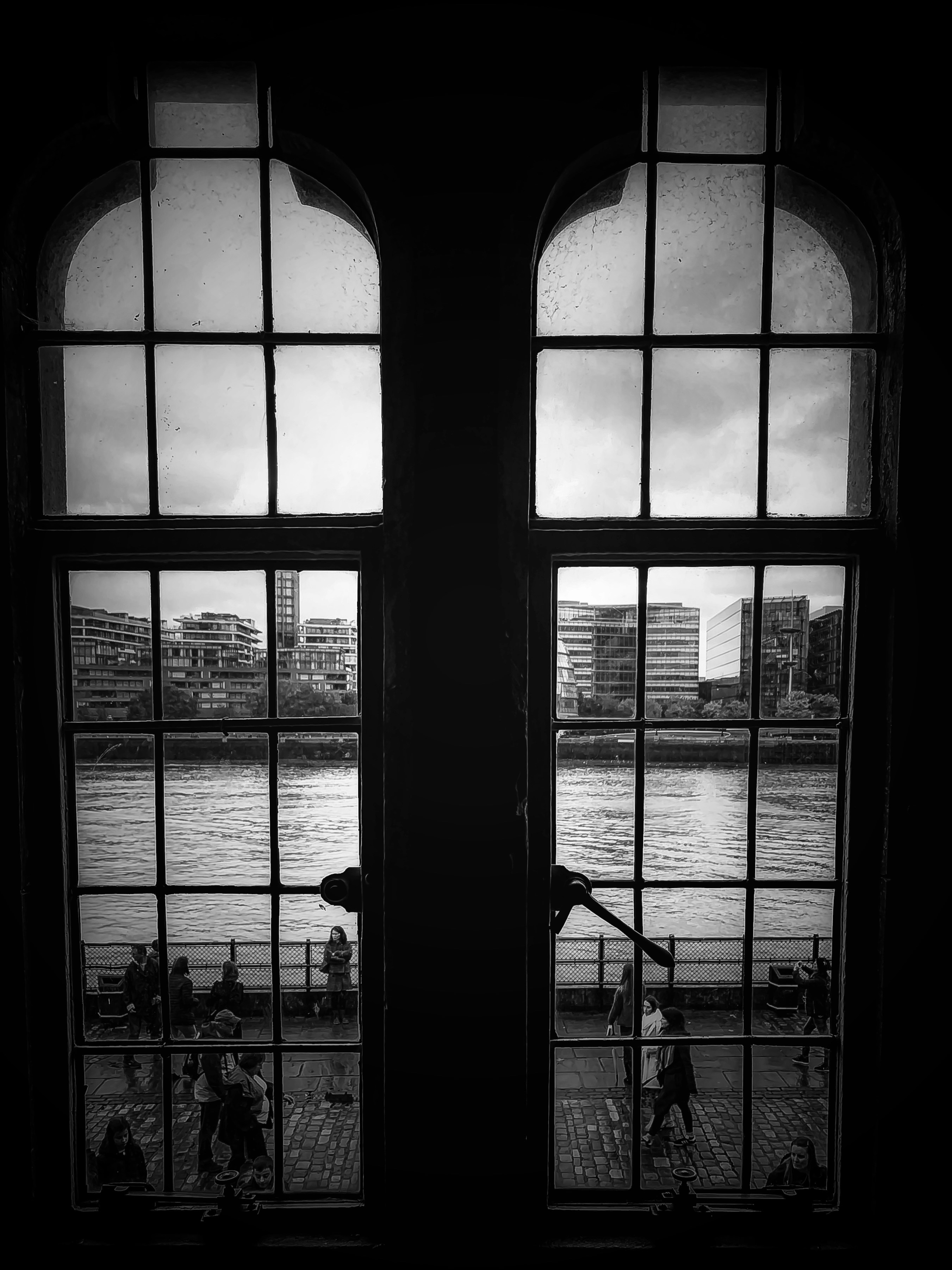 a couple of windows that have a view of a body of water