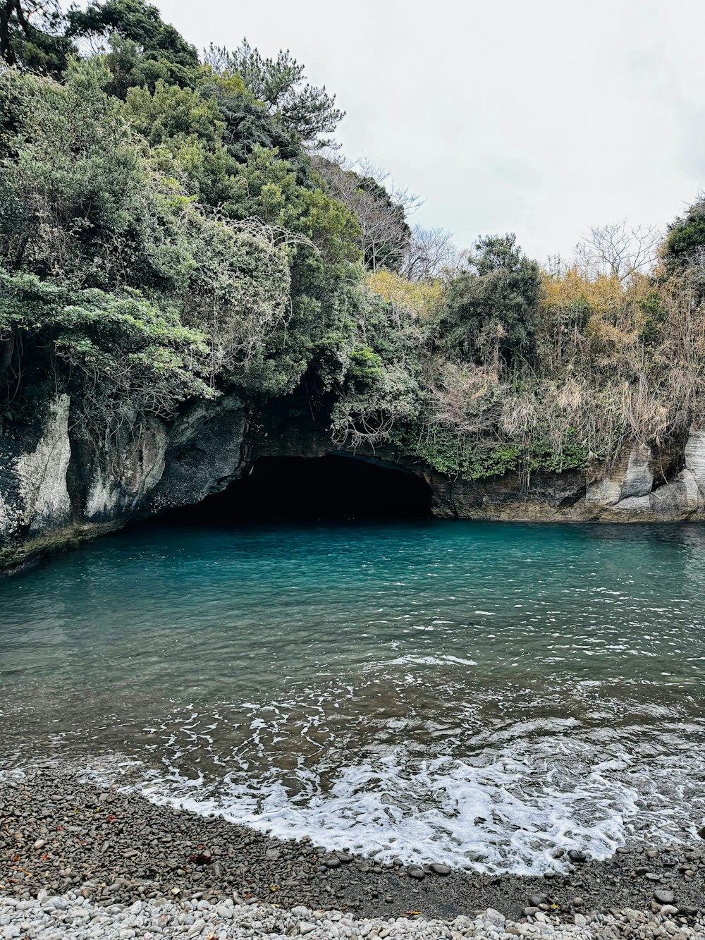 a body of water with a cave in the middle of it