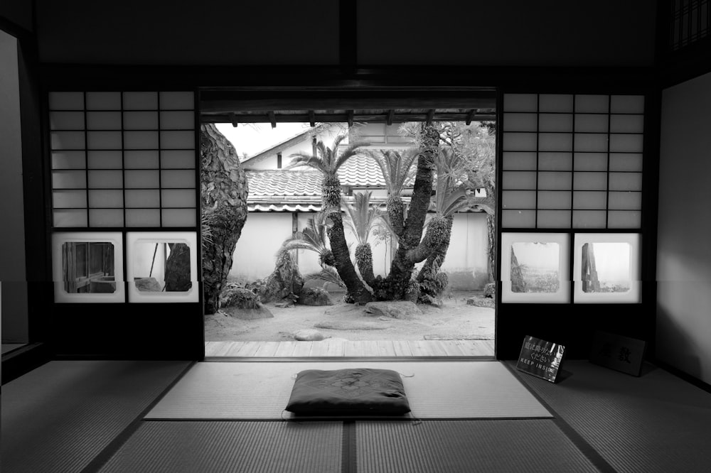 a black and white photo of a room with an open door