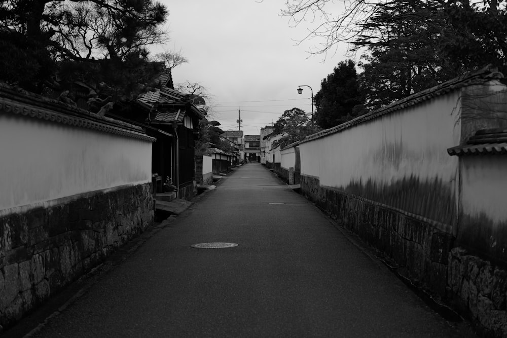 a black and white photo of a narrow street