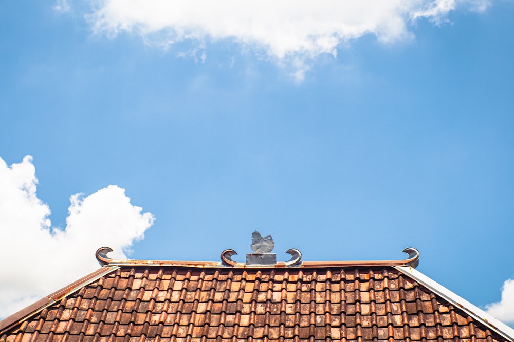 a roof with a weather vane on top of it