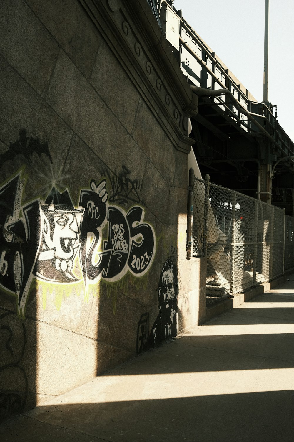 a man riding a skateboard down a sidewalk